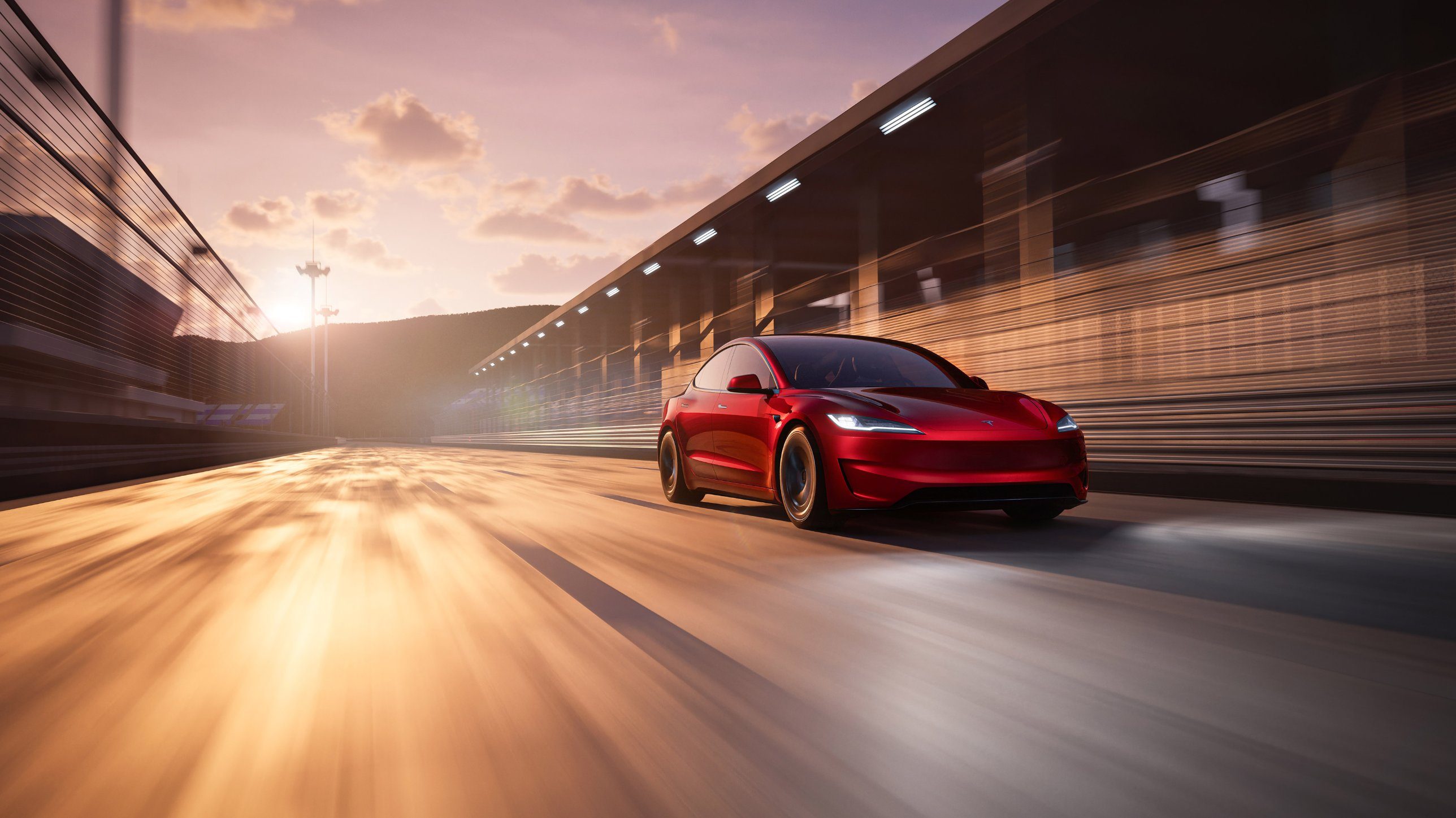 Red Tesla Model 3 driving through a tunnel at sunset