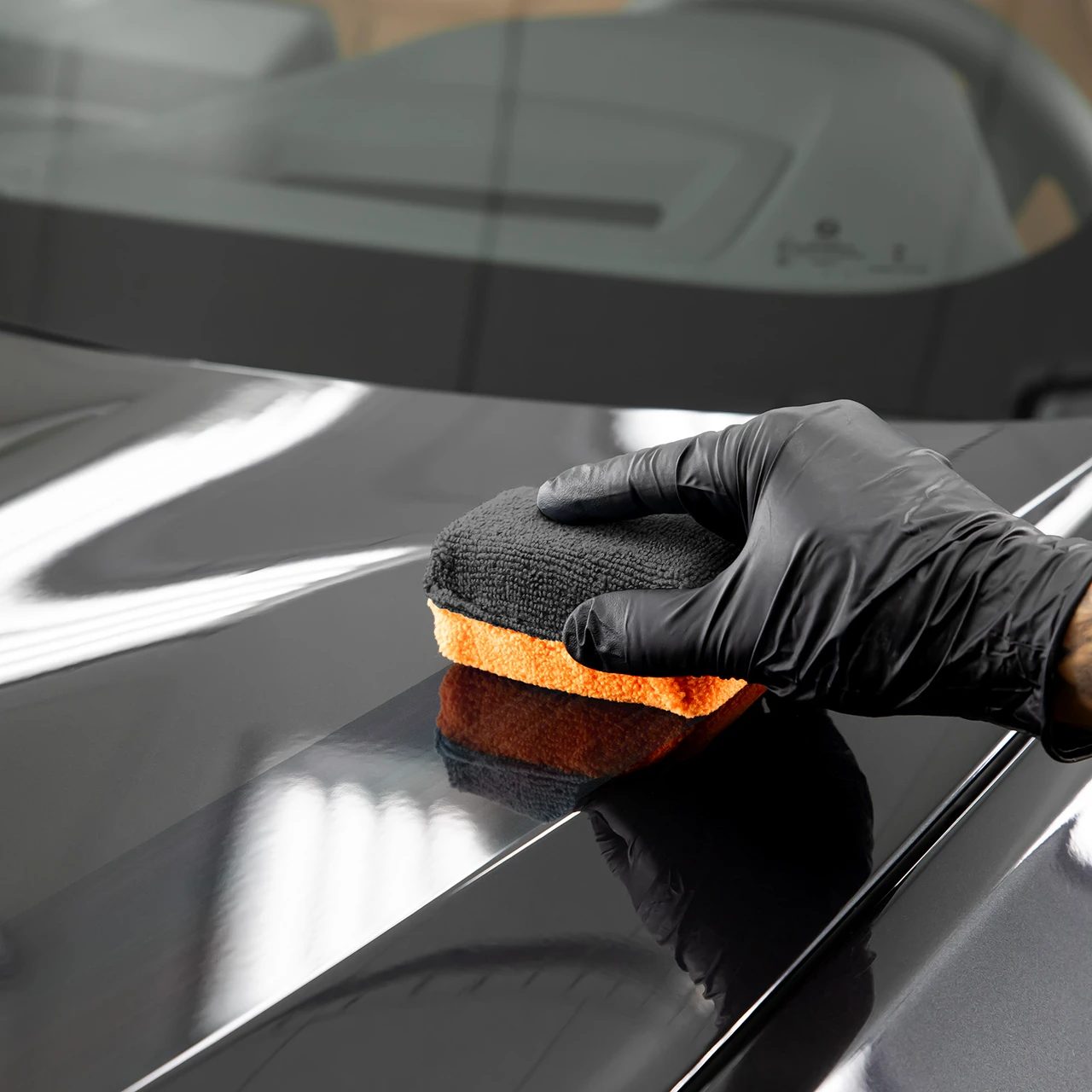 Ceramic coating being applied to black paint