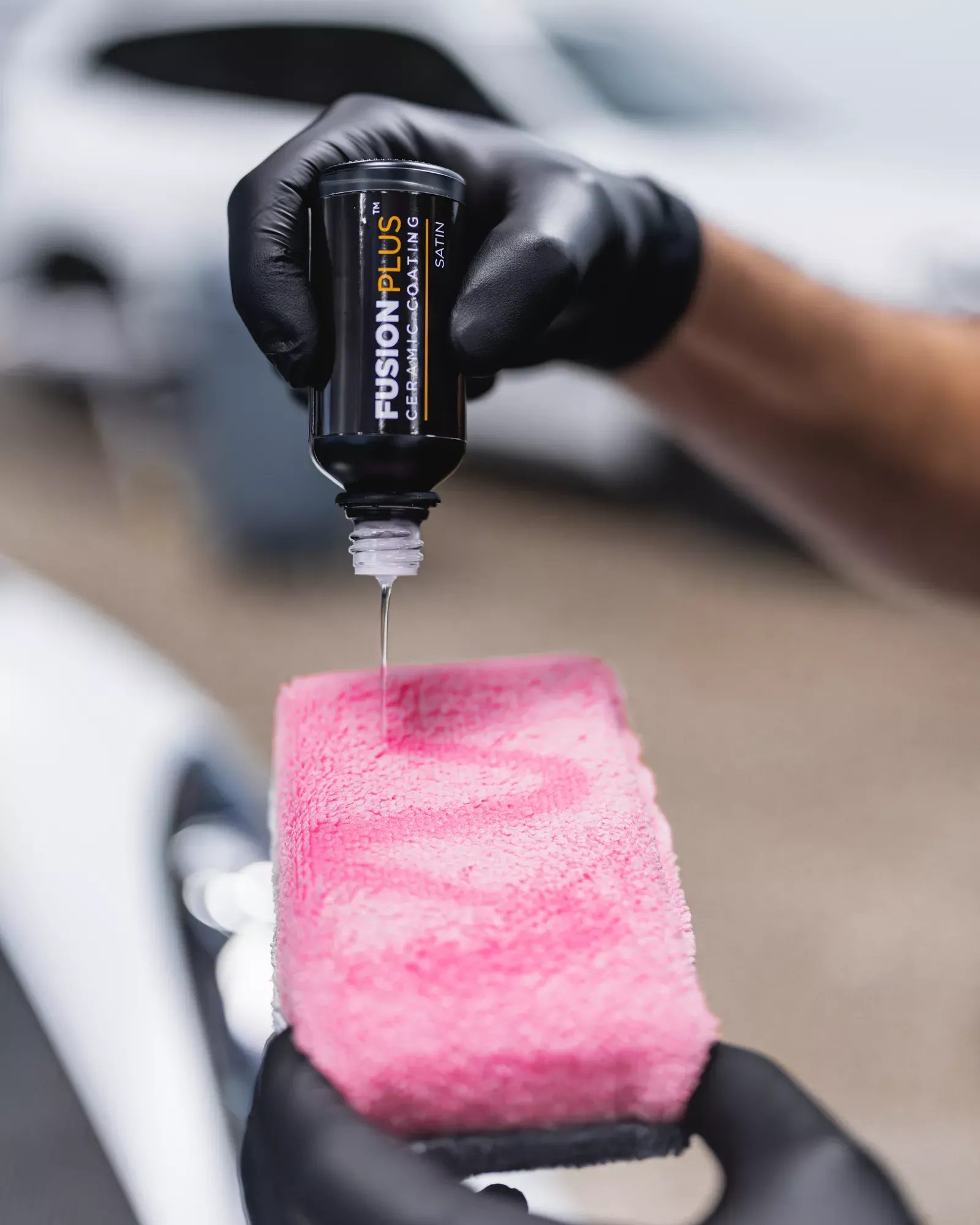 XPEL Fusion Plus Satin ceramic coating poured onto an applicator