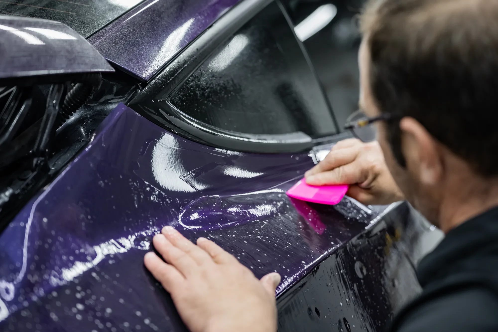 XPEL Color PPF being installed on a purple car