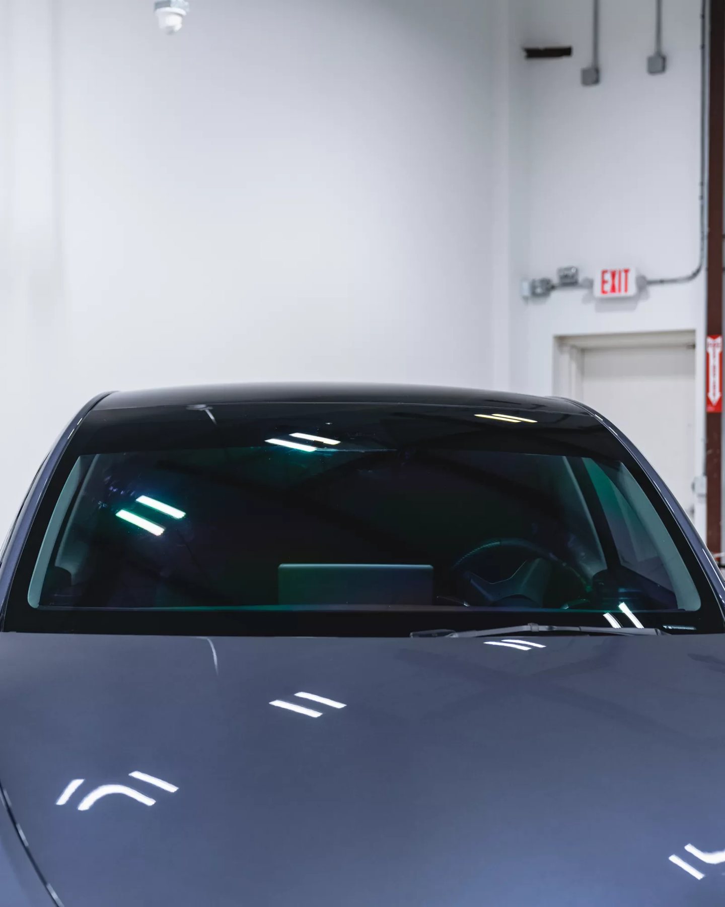 Tesla windshield with clear XPEL window film at Autograff